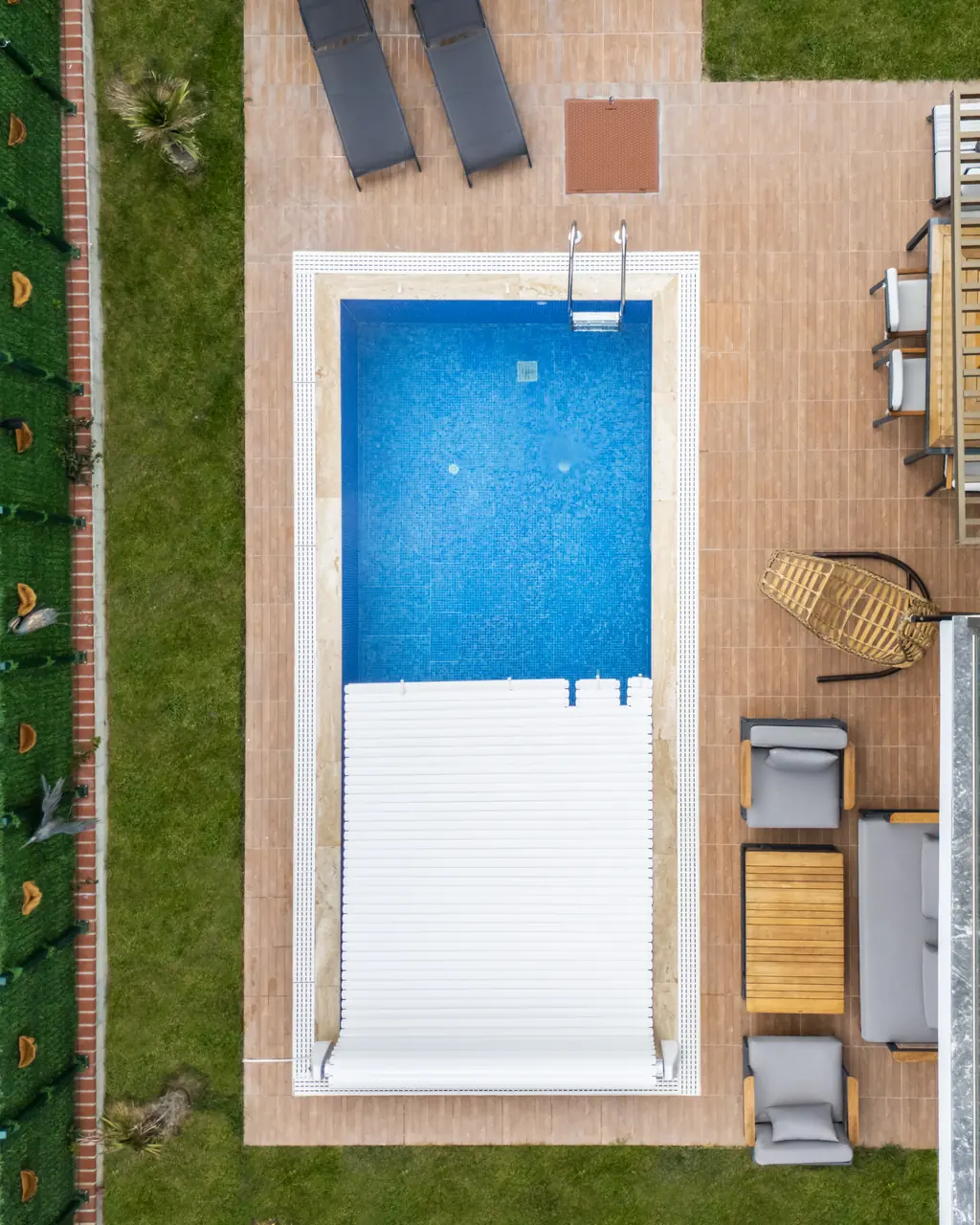 Partially covered pool beside a timber terrace – No1Pool