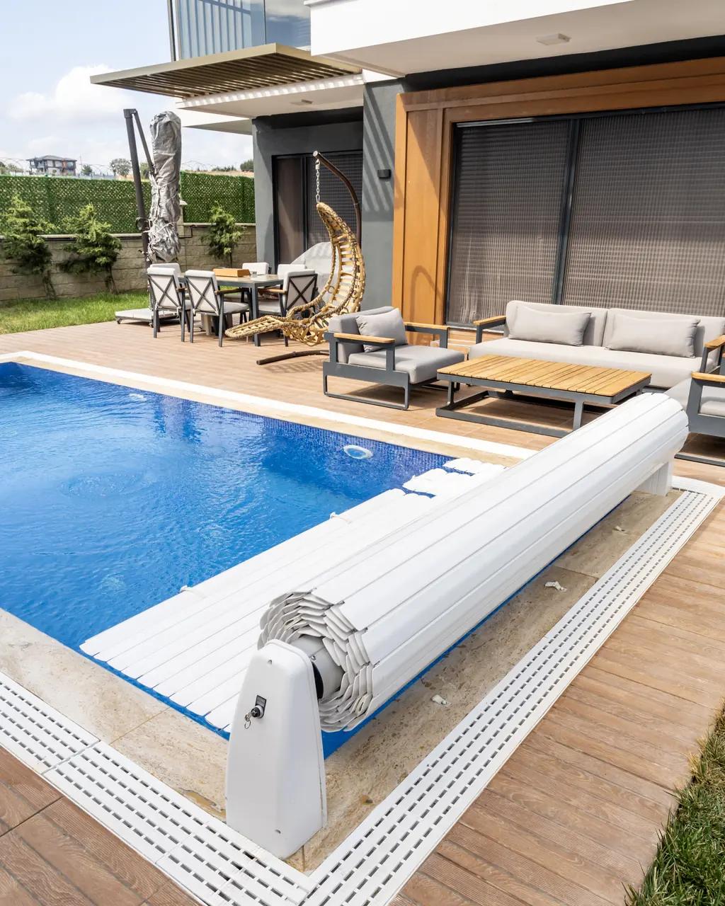 Partially open pool cover beside the terrace – No1Pool